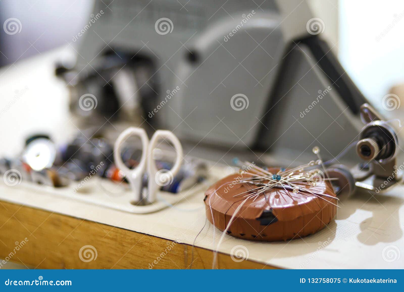 Bunch of Needles and Set of Colored Threads Near Sewing Machine