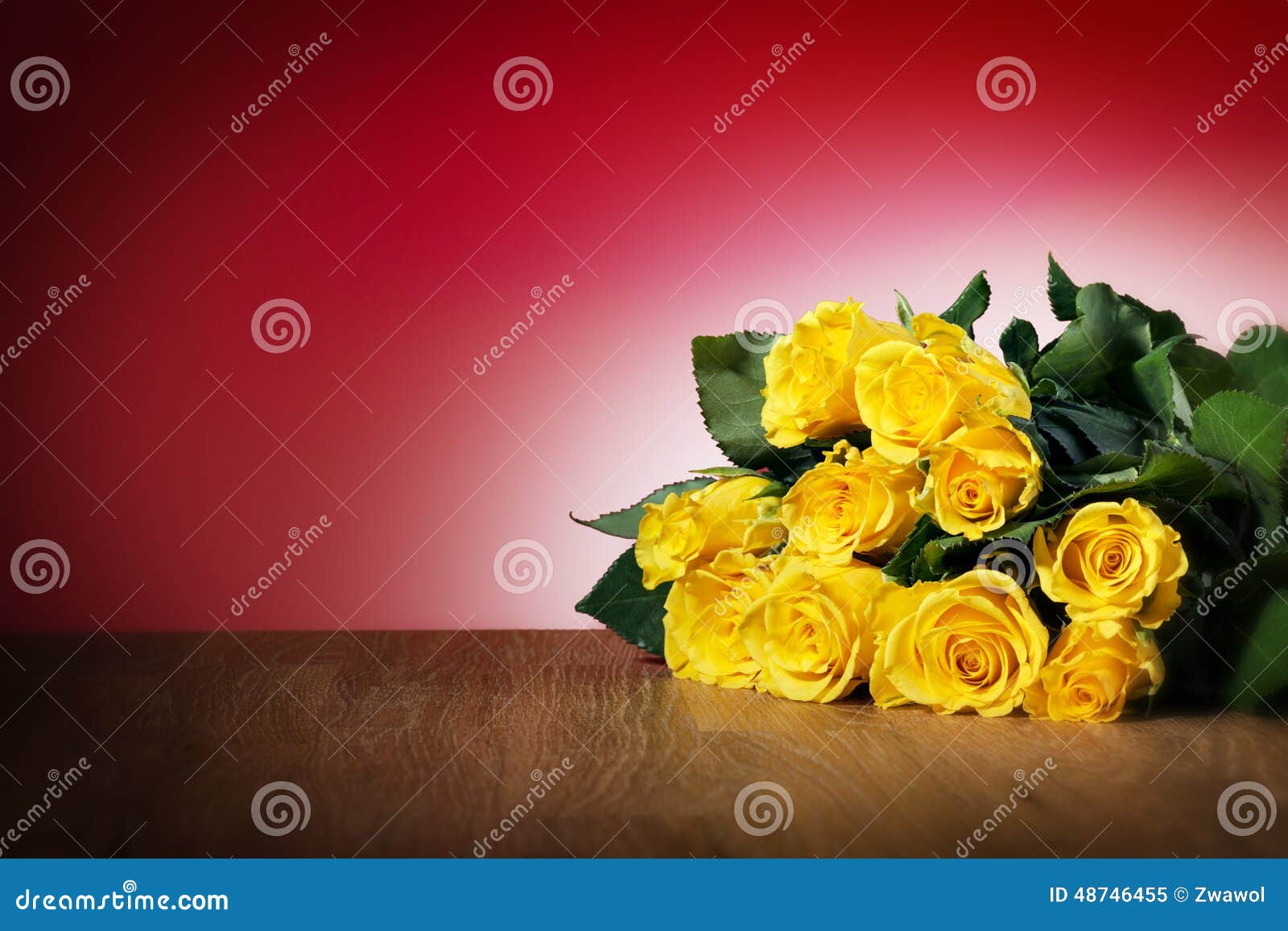 Bunch of yellow roses on a table and with red background, free space