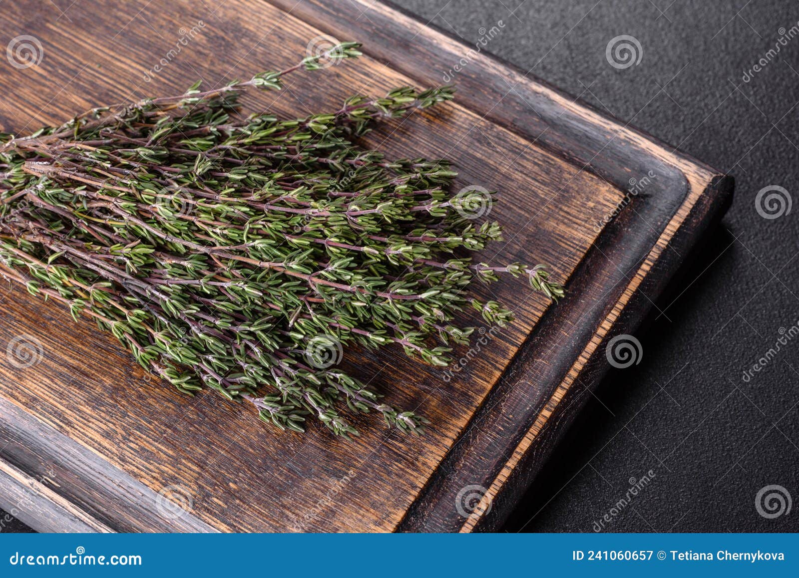 Bundle of Fresh Thyme Grass on a Wooden Cutting Board Stock Image