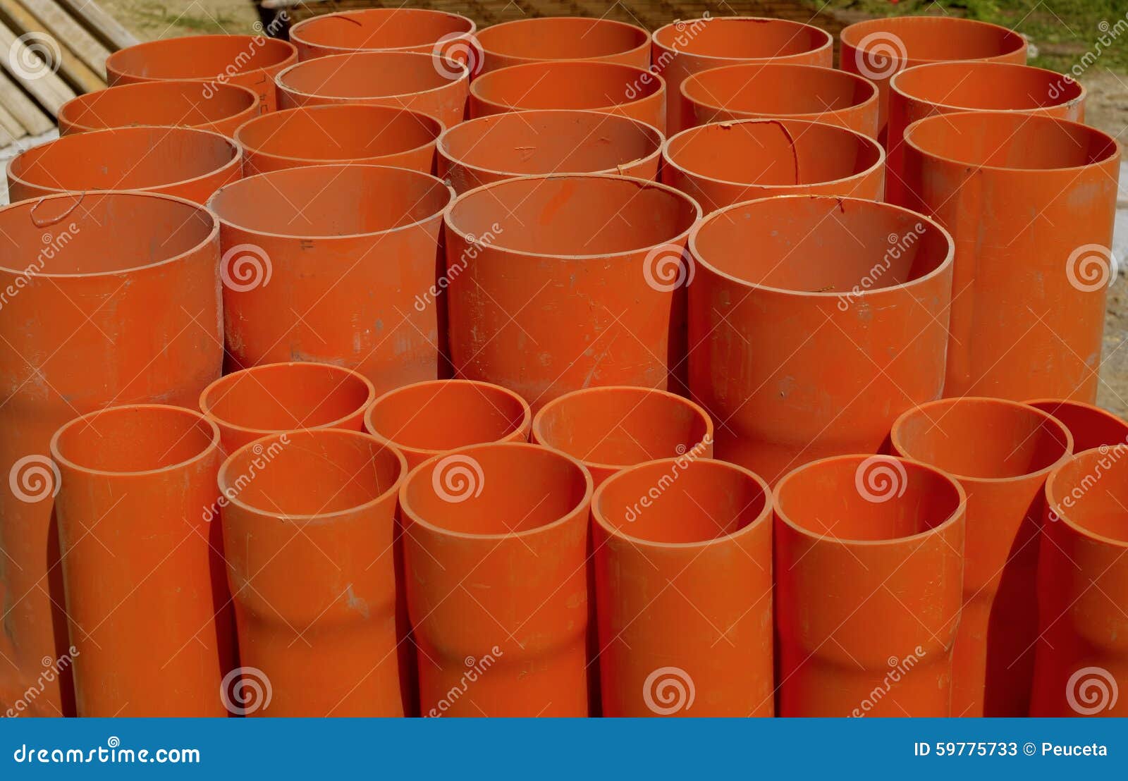 A bundle of red pvc pipes stock image. Image of drainage 59775733