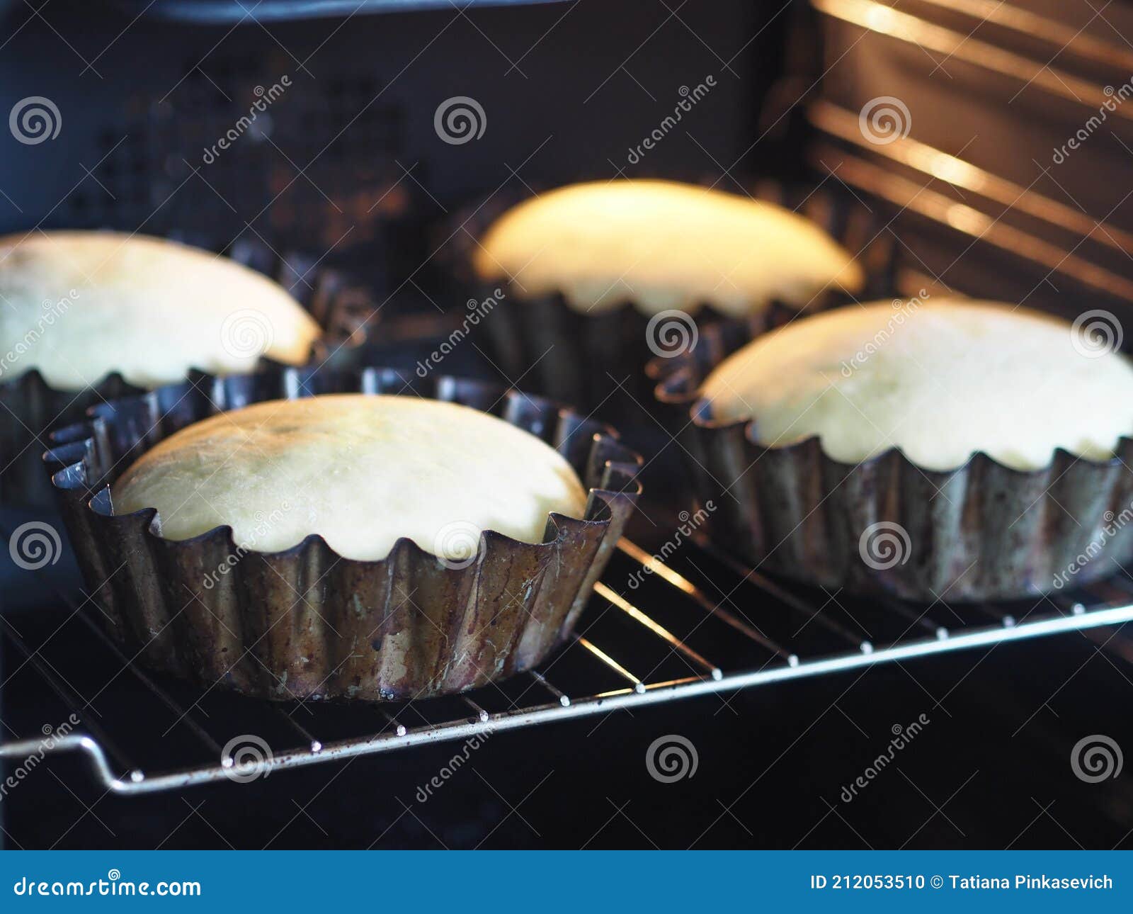 Buns are Baked in Baking Pans in the Kitchen Oven.Homemade Cake Stock