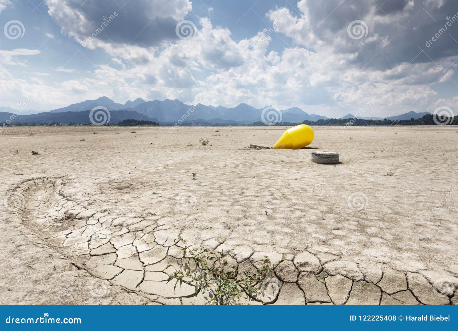 buoy in the waterless forggensee lake in bavaria, germany