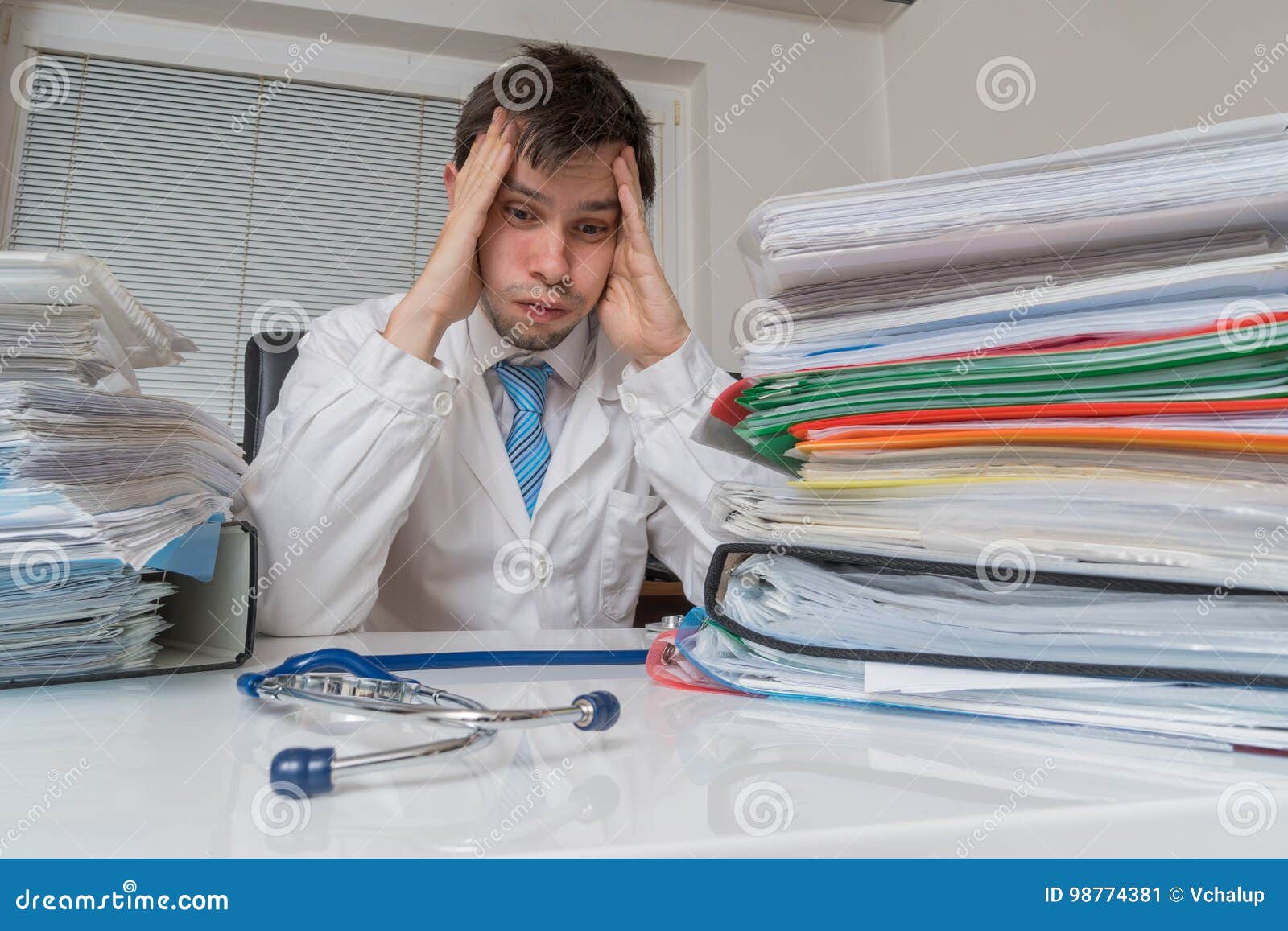 bureaucracy in medicine concept. tired overworked doctor have many documents on desk