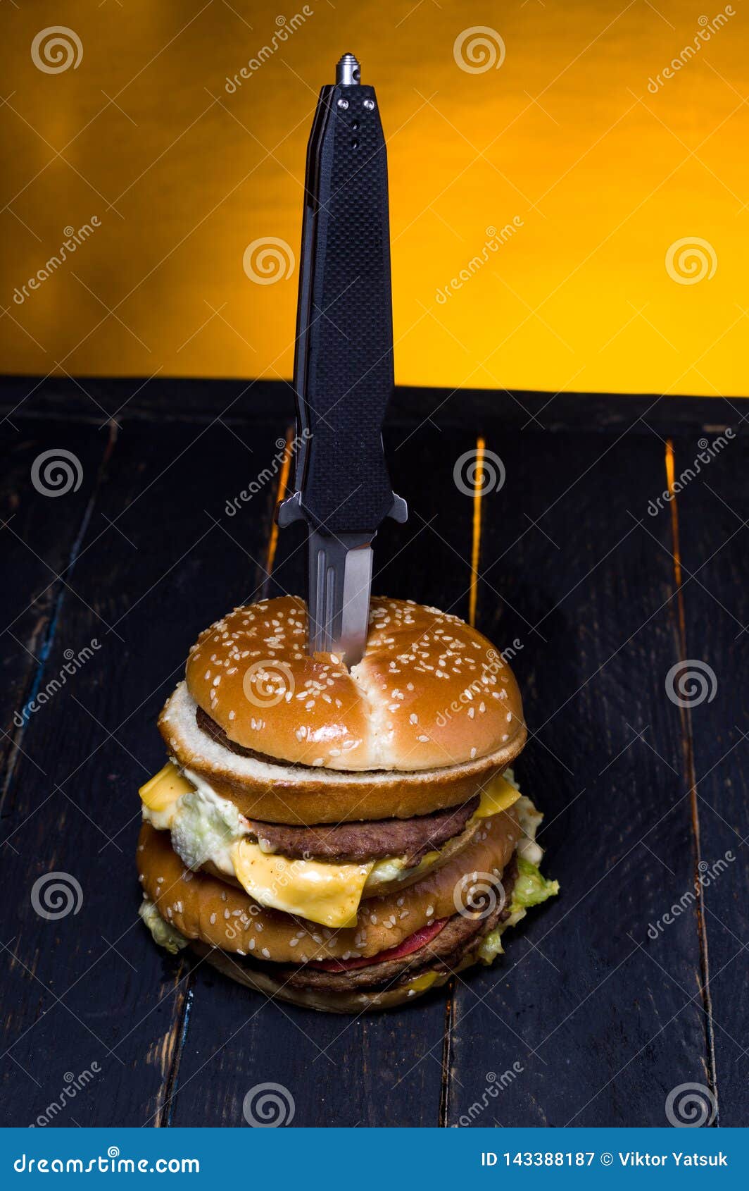 burger with meat pierced with a knife. view of the burger from above