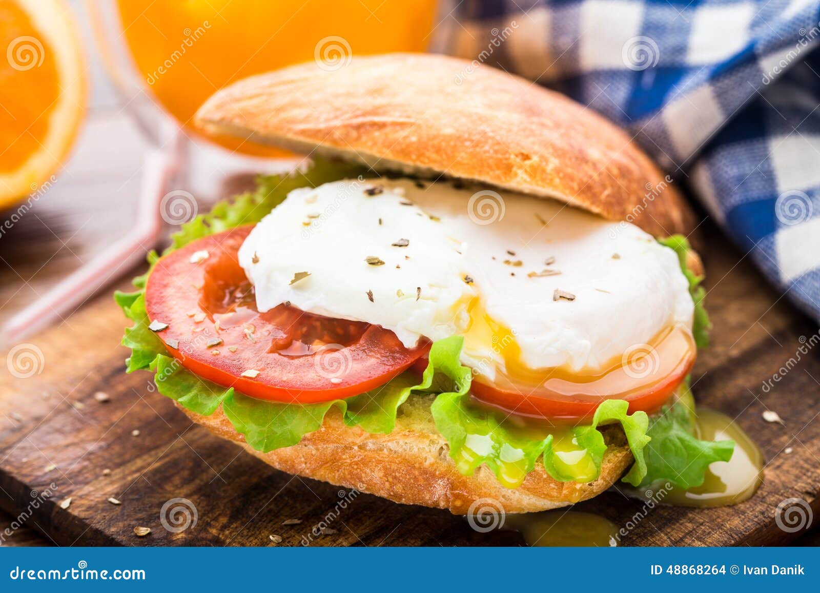 Burger with pouched egg and tomato for breakfsat