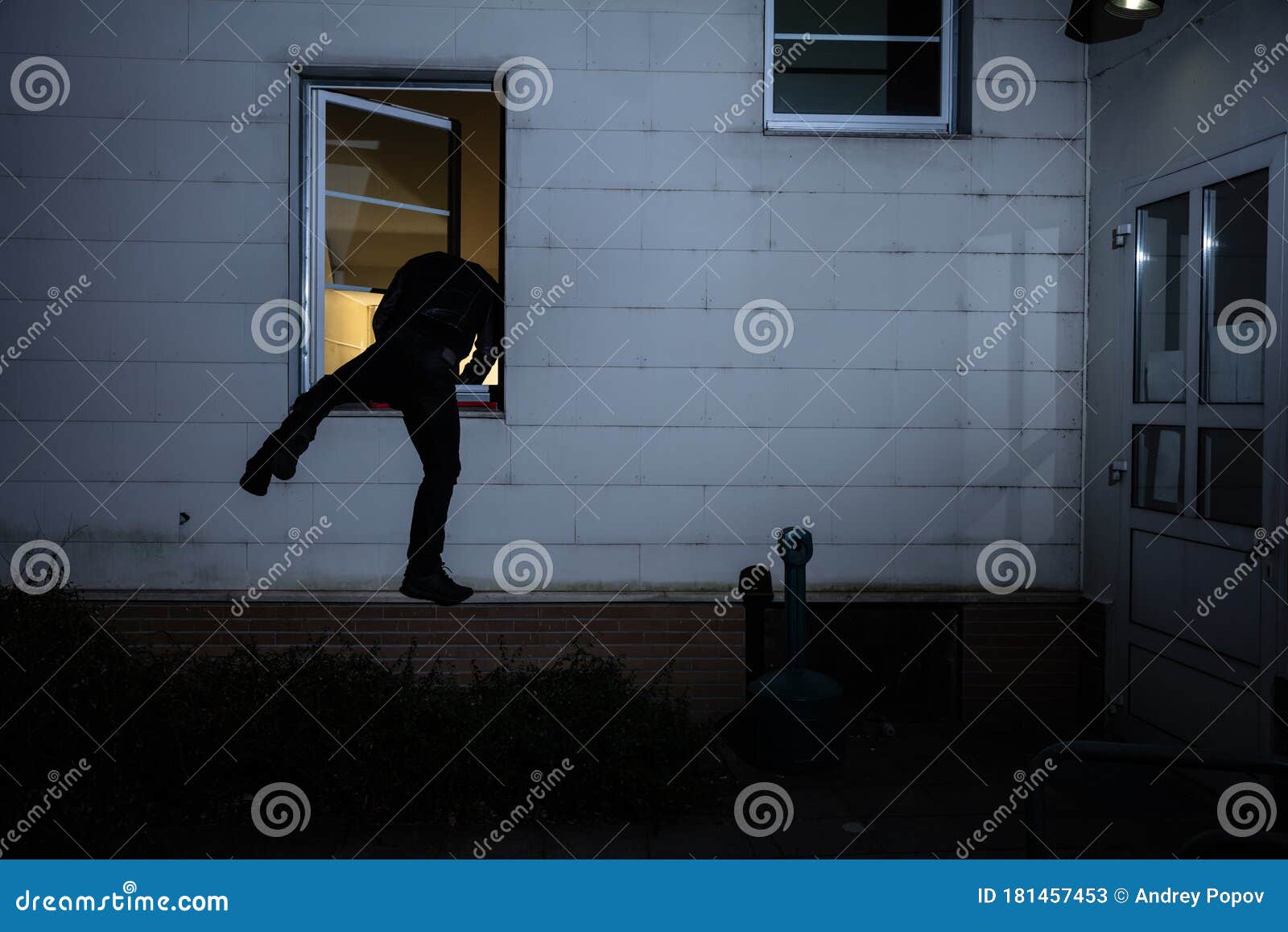 burglar entering in a house through a window