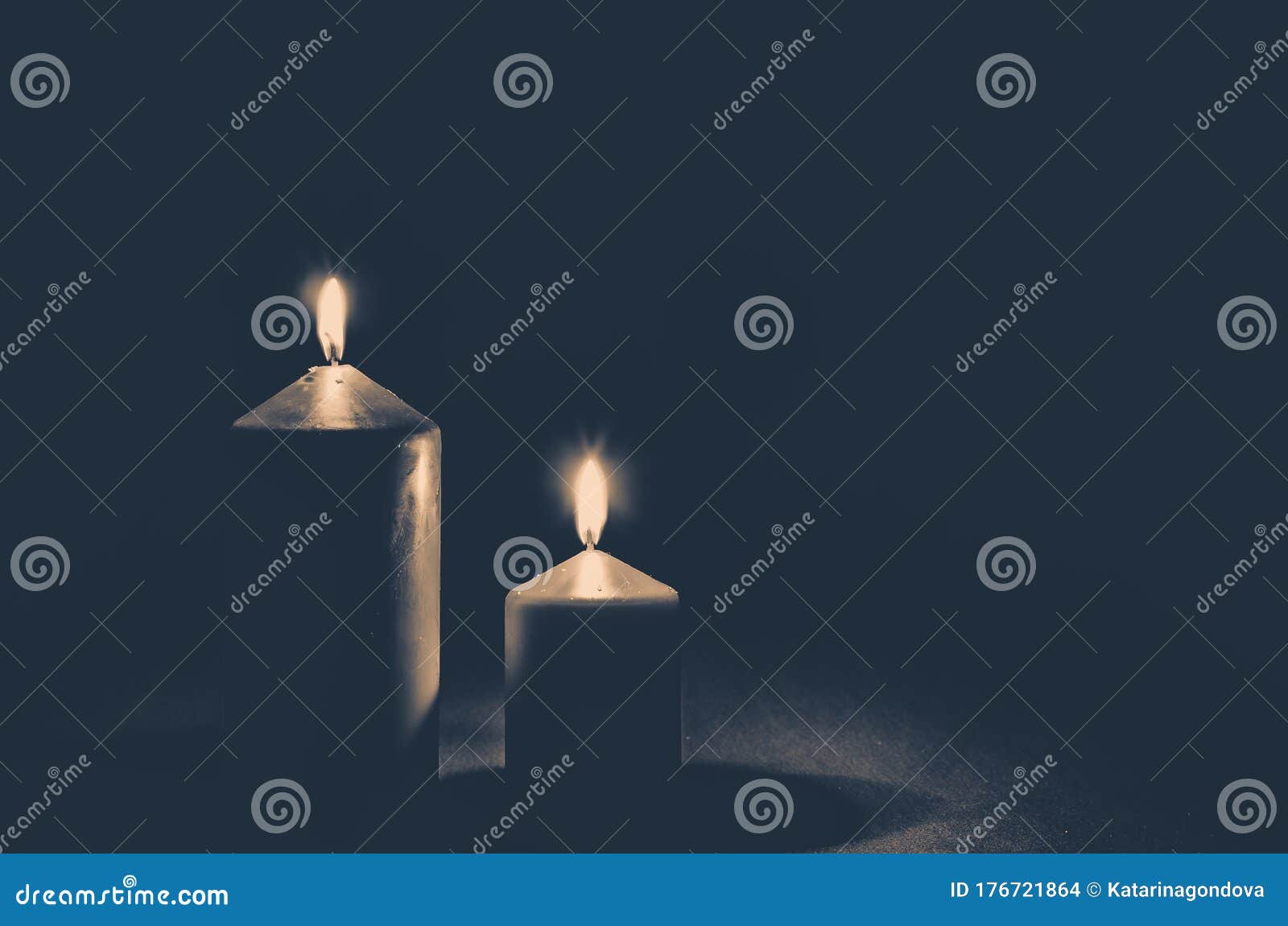 Burial Concept with Two Golden Burning Candles Against Black Background ...