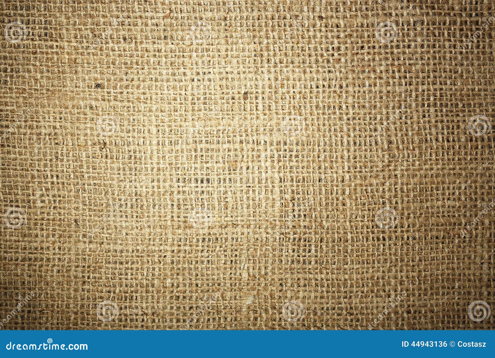 Unevenly lit burlap texture for background use