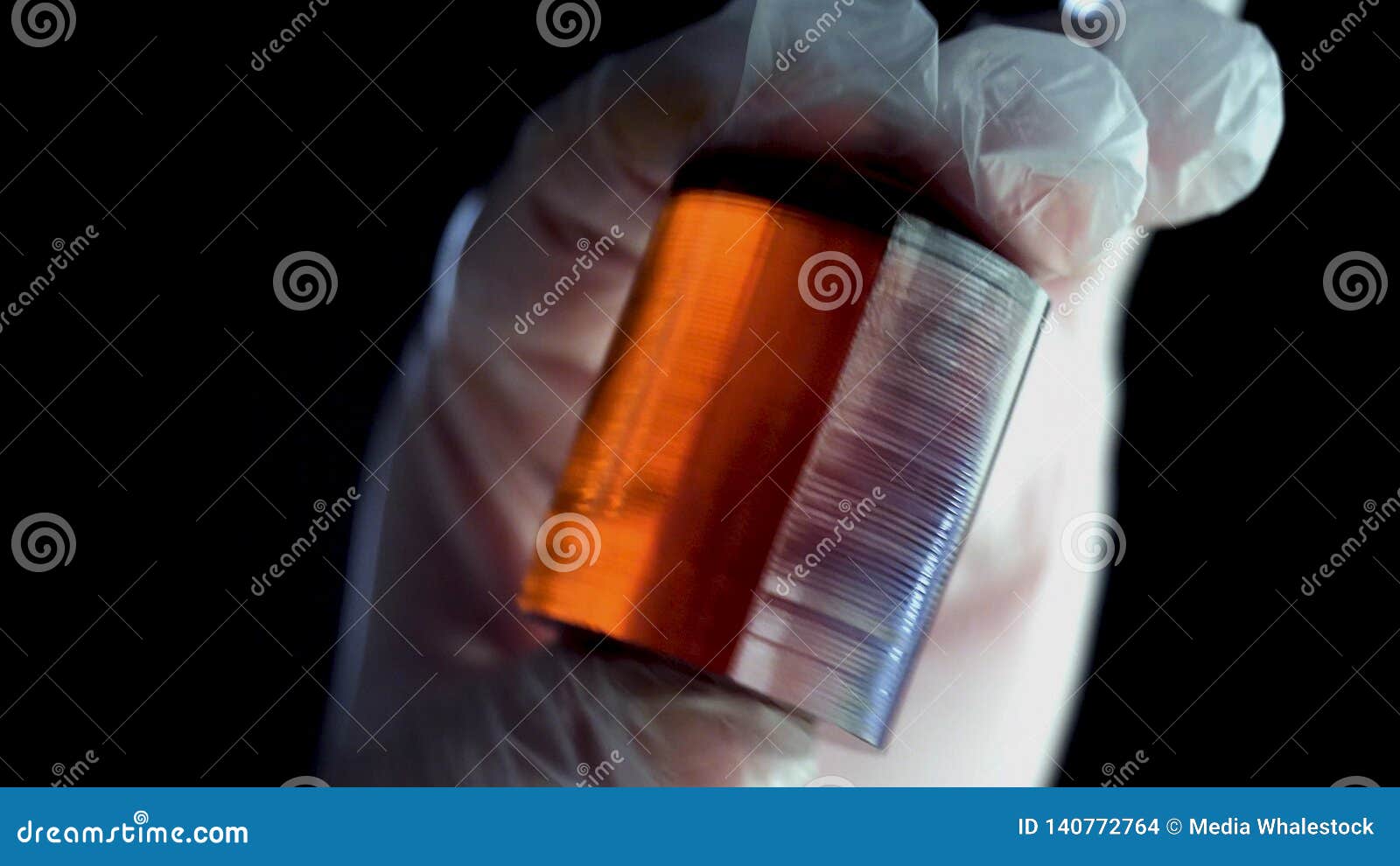 Burned Piece of Orange Mineral. Close-up of Gloved Hands Holding Piece ...