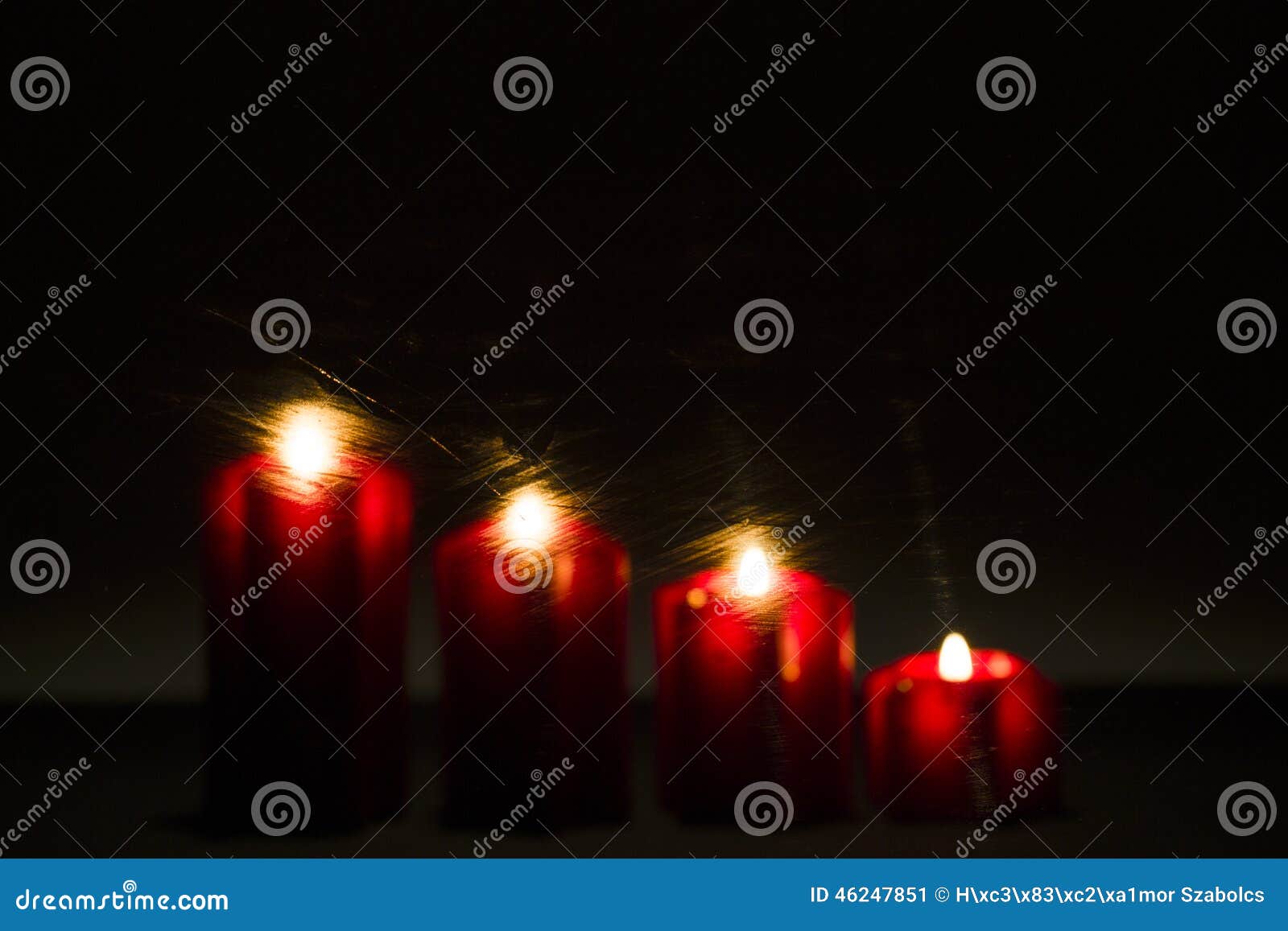 burning advent candles on the frosted window with 2015 new year'
