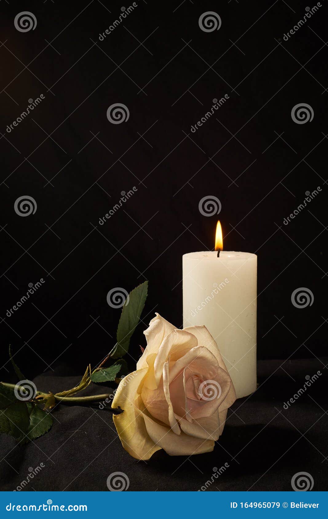 Burning Candle and a Beautiful Rose on a Black Background Stock Image