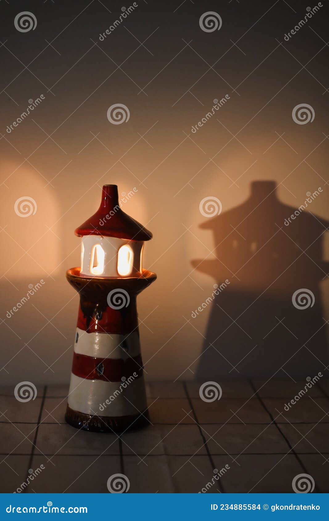Burning Candle in a Candlestick in the Shape of a Lighthouse with a