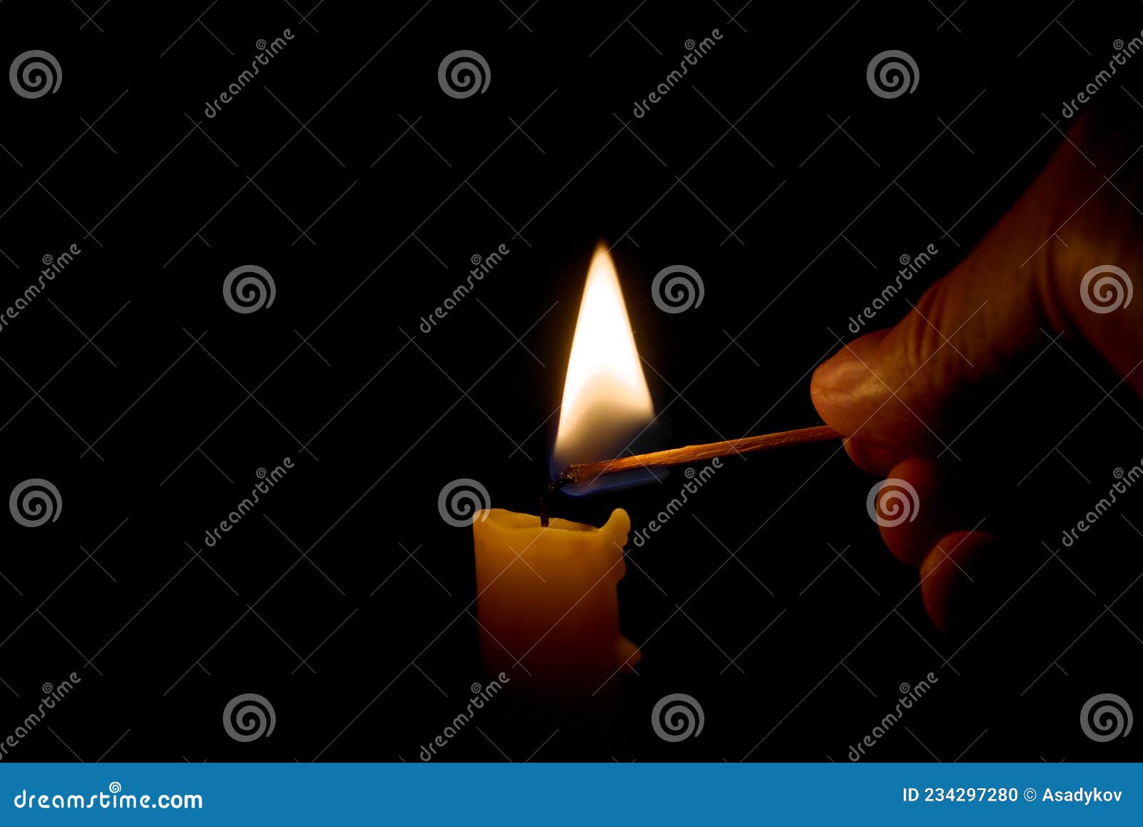 Burning Candle in the Darkness. Lighting Candle with Match Stock Photo