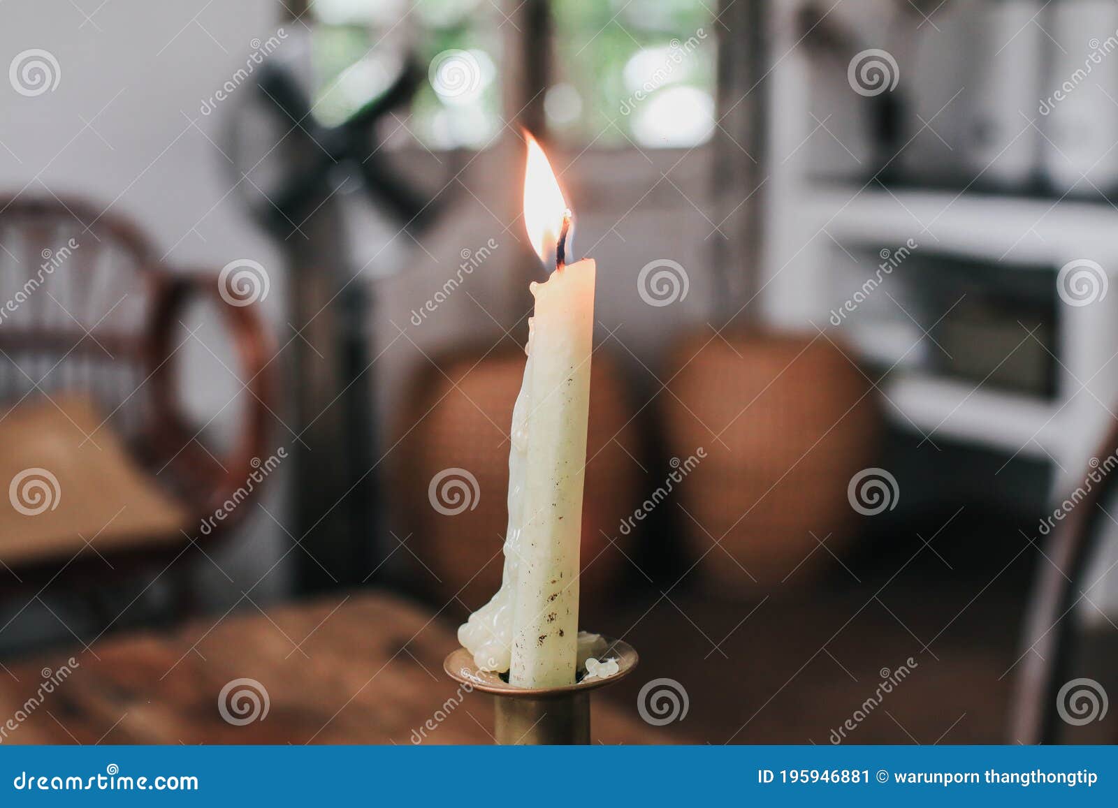 Burning Candle on Dinner Table Setup with Holiday Decorations in