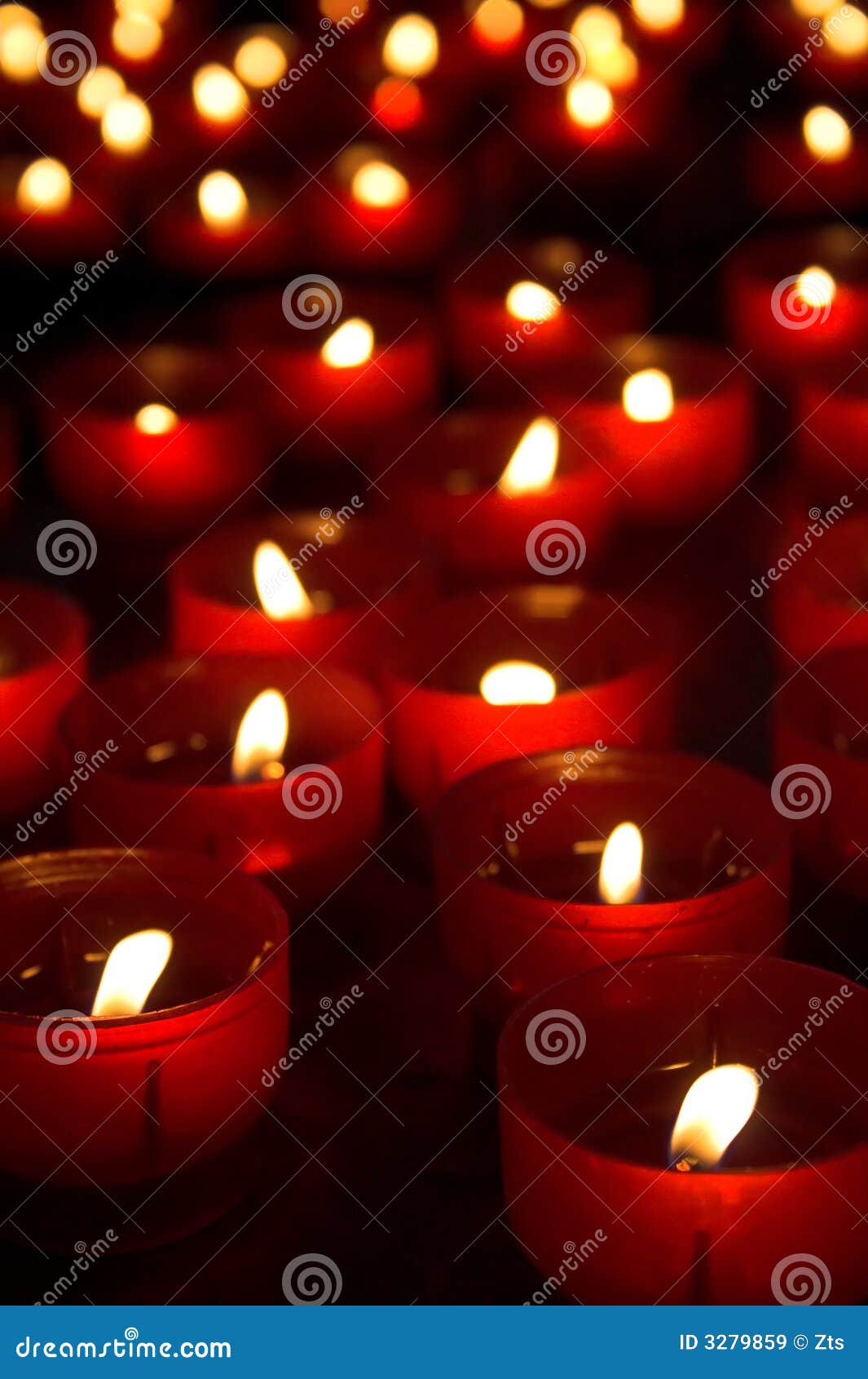 Burning Candles In The Temple On The Background Of A Golden Cross