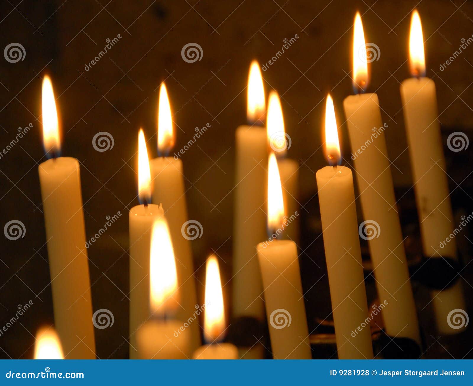 Burning Candles In The Temple On The Background Of A Golden Cross