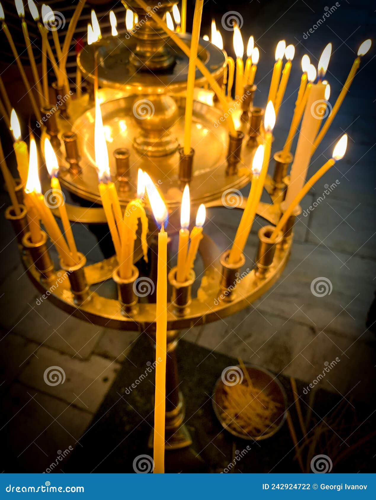 Burning Candles with One Lighted Candle in Orthodox Church. Editorial