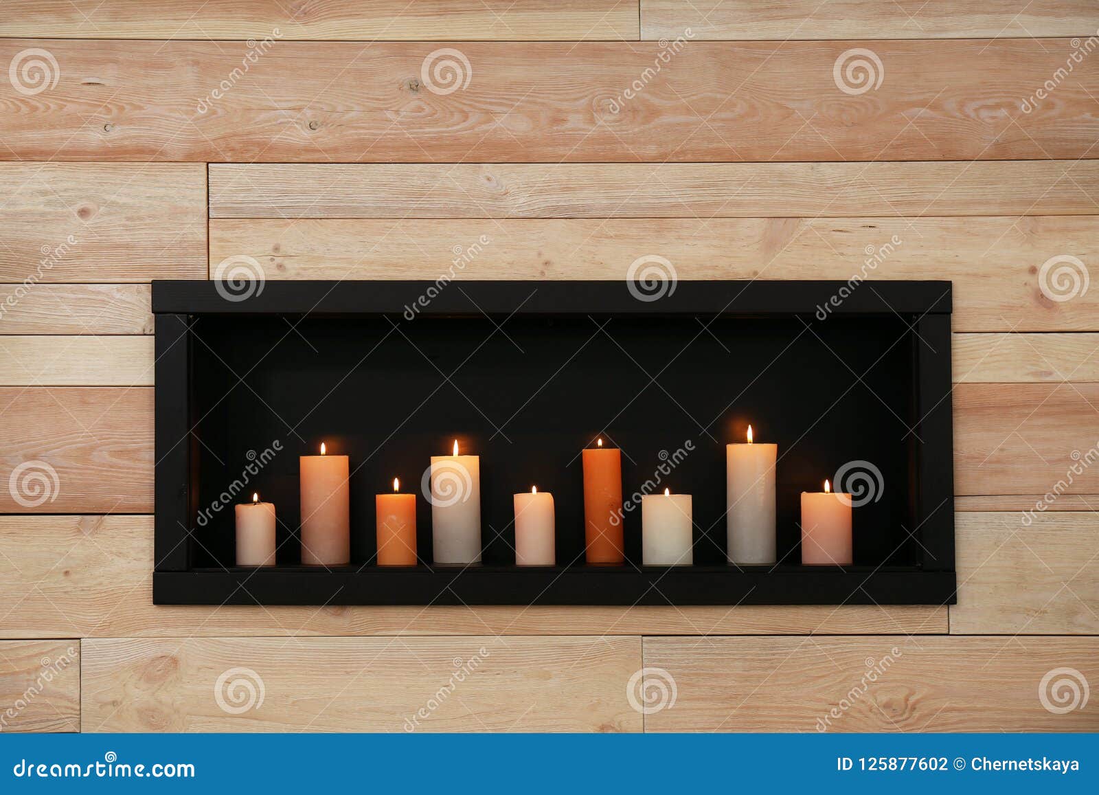 Burning candles on shelf stock photo. Image of comfort 125877602