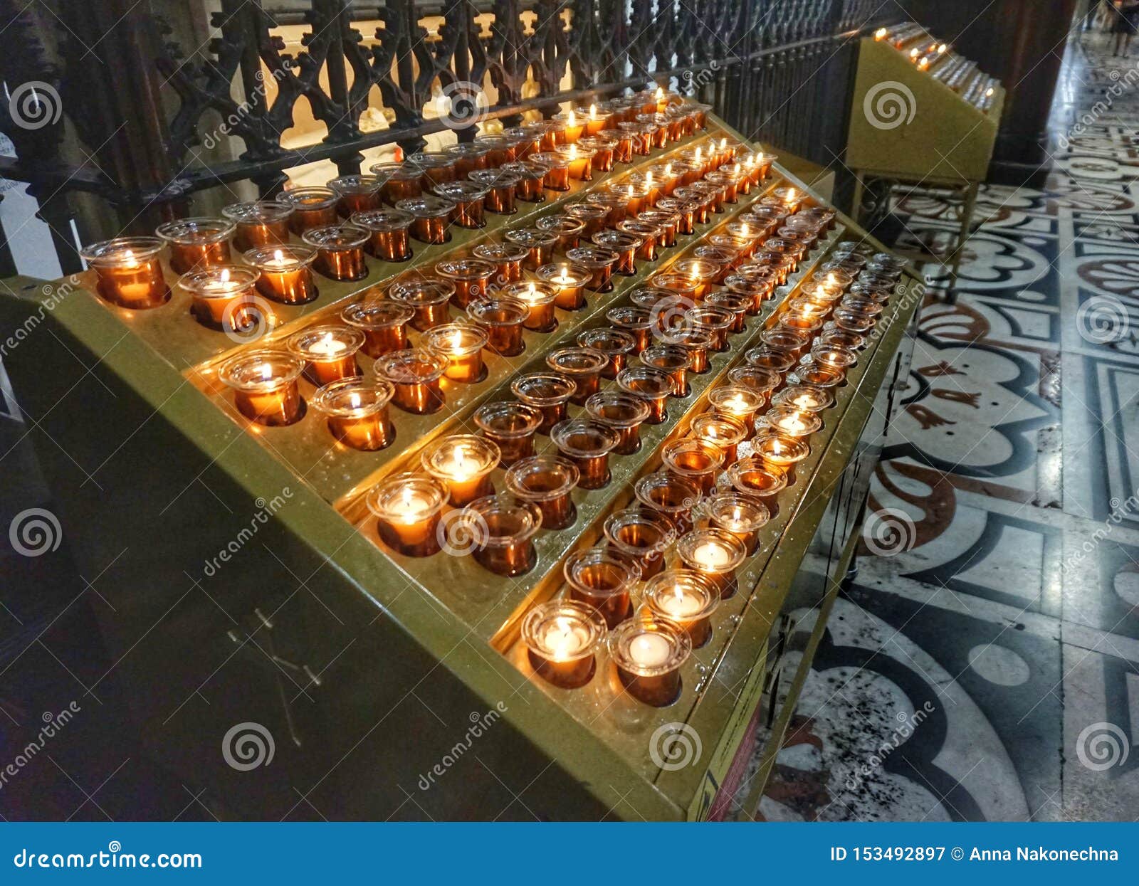 Burning Candles on a Stand in One of the Catholic Churches Editorial