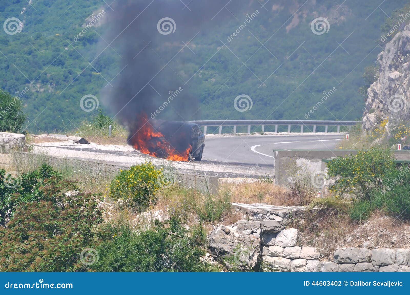 Burning car on highway stock photo. Image of black, cliff 44603402