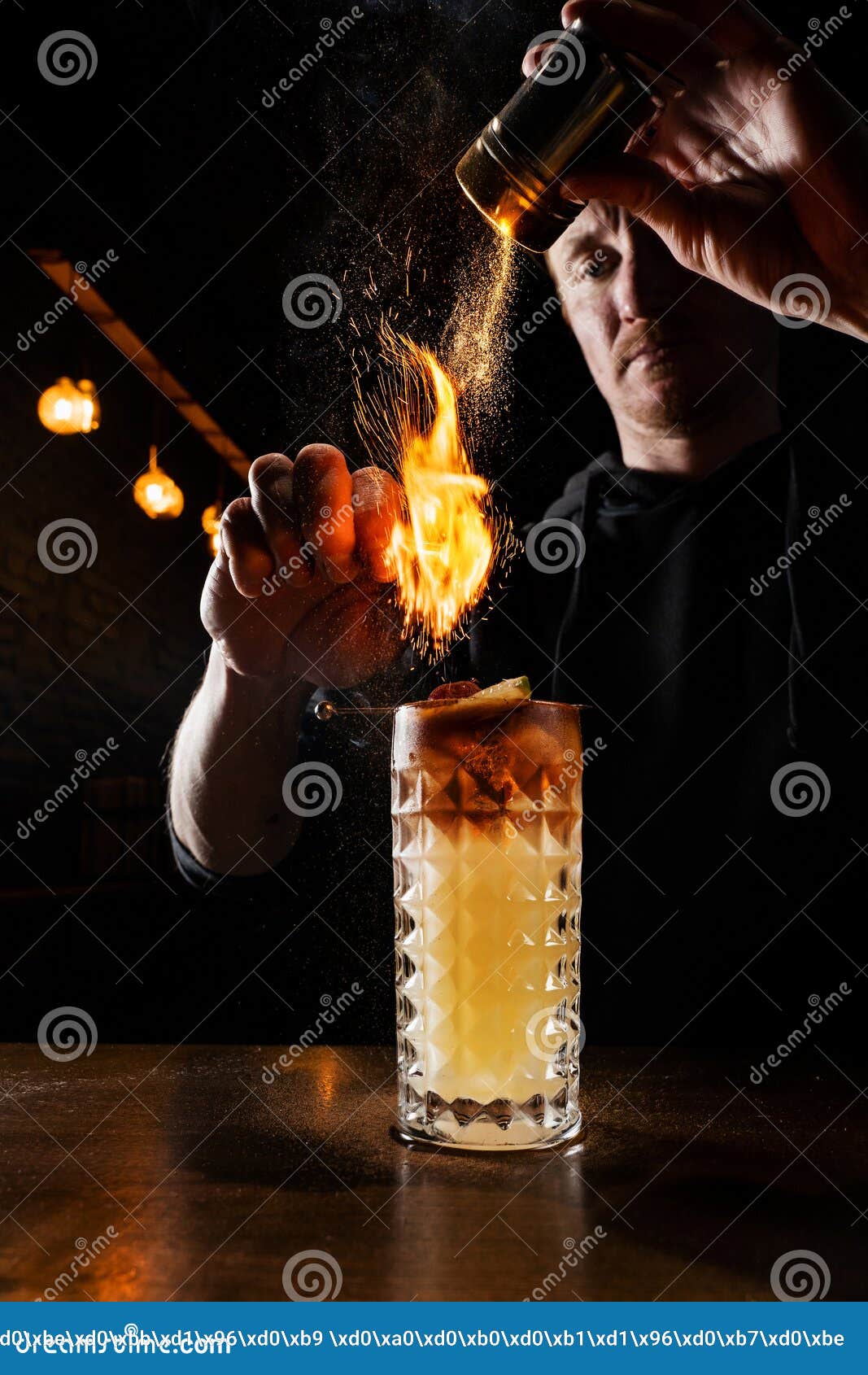 Burning Cinnamon in Cocktail. Bartender Pours and Fire Burns Cinnamon