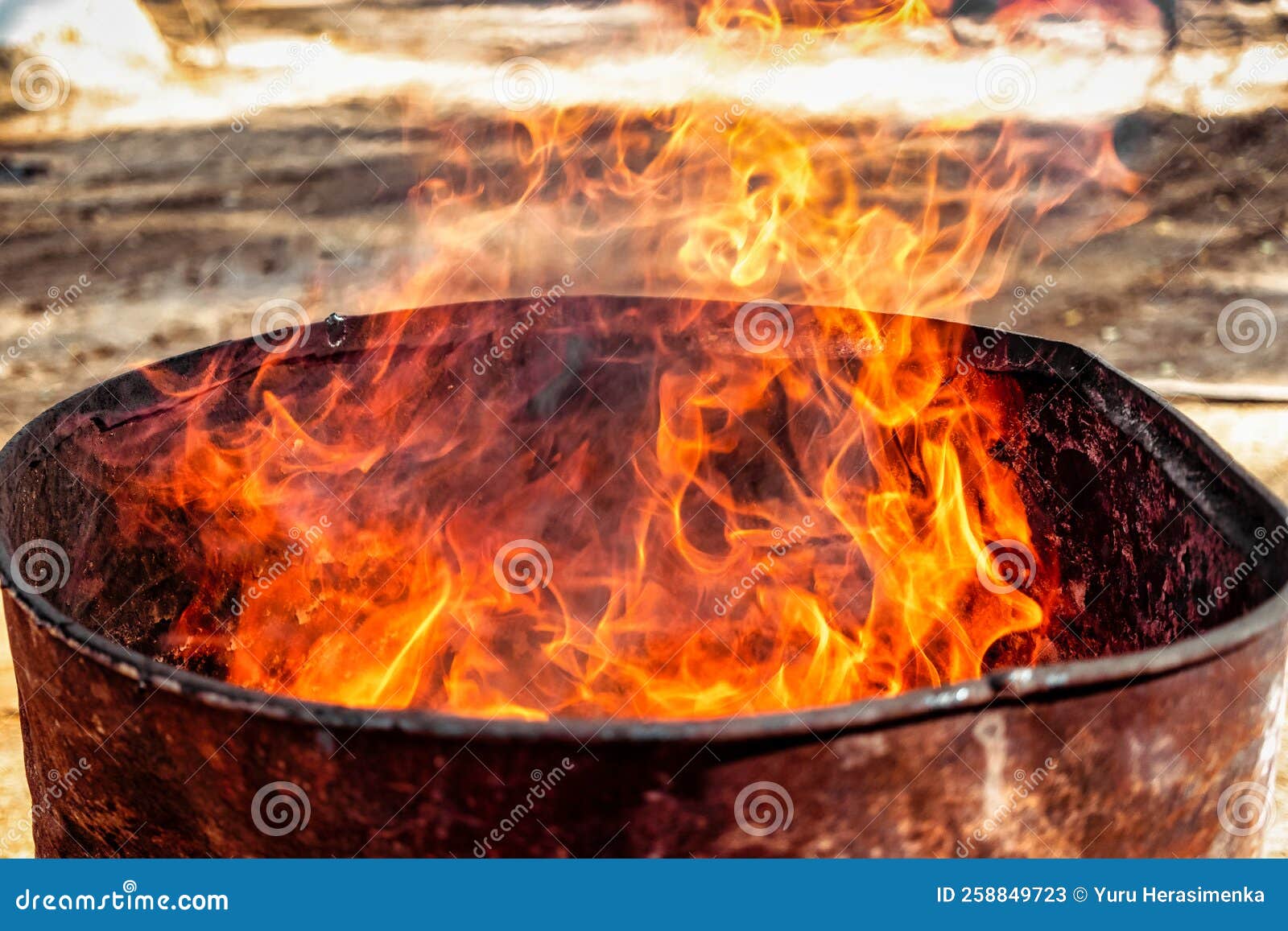 Burning Fire in a Barrel Closeup. Bright Flame. Open Flame Heating