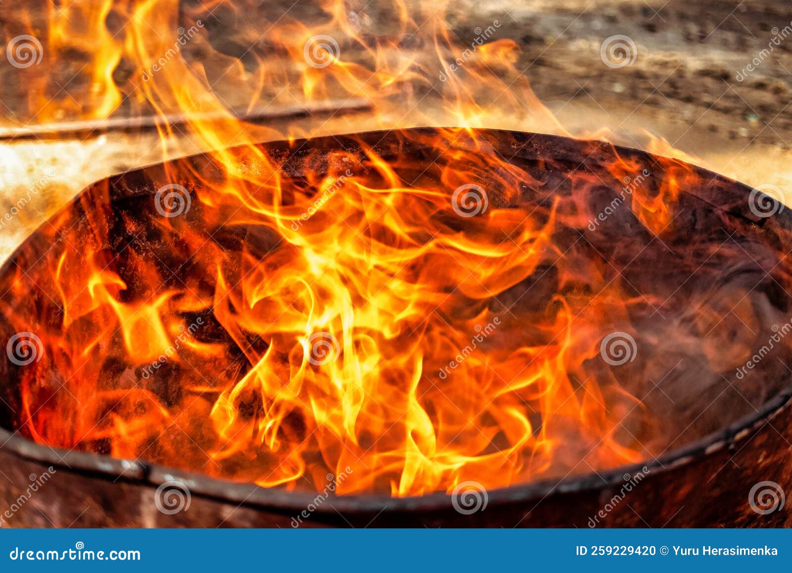 Burning Fire in a Barrel Closeup. Bright Flame. Open Flame Heating
