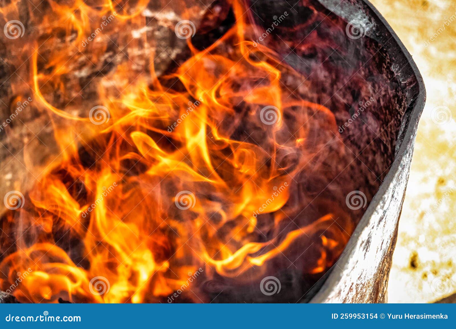 Burning Fire in a Barrel Closeup. Bright Flame. Open Flame Heating