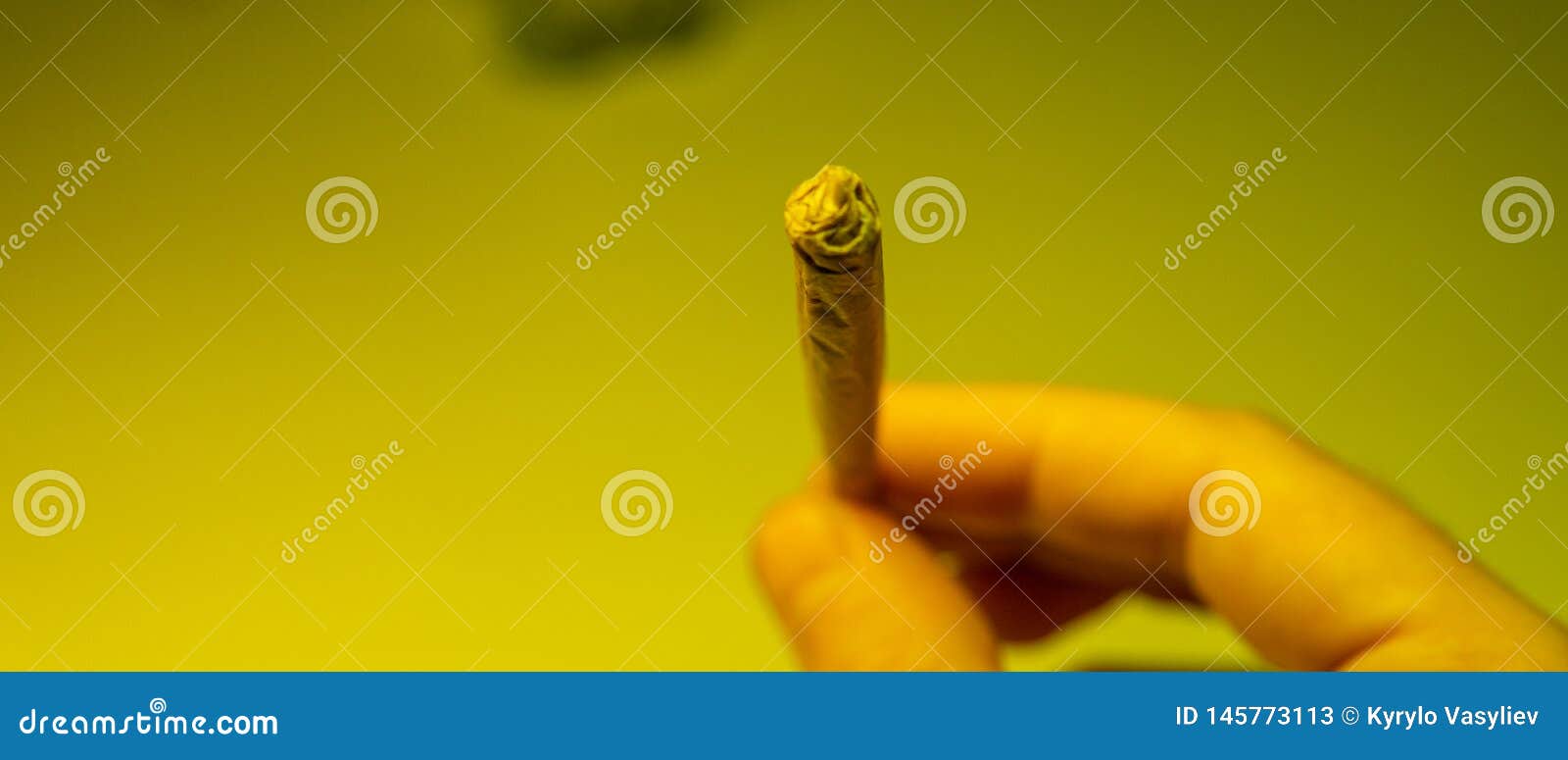 Burning Joint with Marijuana in Tha Mans Hands Closeup. Stock Image