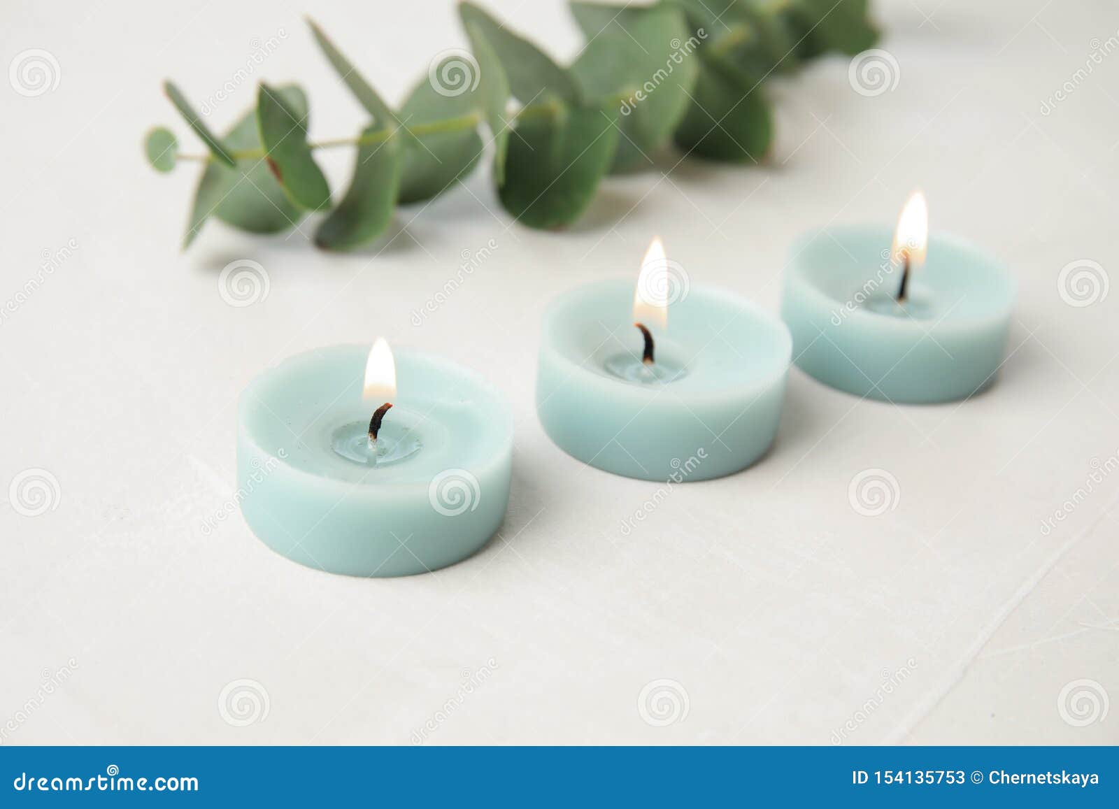 Burning Light Blue Candles and Eucalyptus Branch Stock Image Image of