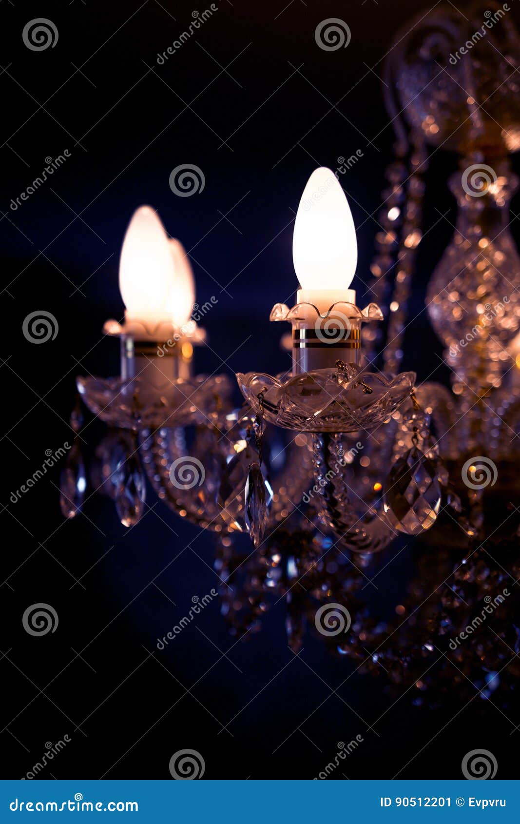 A Burning Light Bulb on a Crystal Chandelier Stock Image Image of