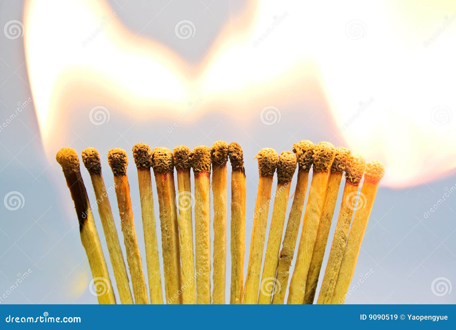 A Row Of Burning Matches On A Black Background. The Flame Moves From