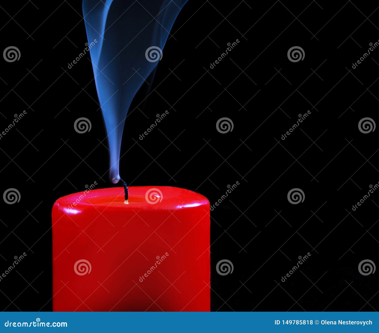 Burning Red Candle with Fading Flame and Smoke on a Black Background