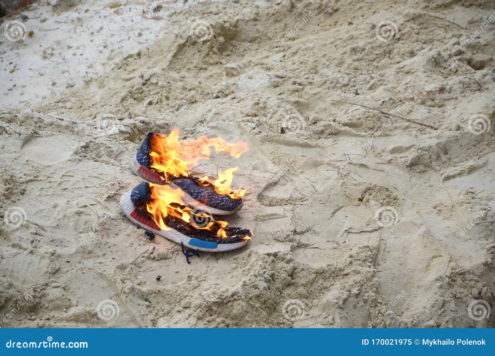 Burning Sports Sneakers or Gym Shoes on Fire Stand on Sandy Beach Coast ...