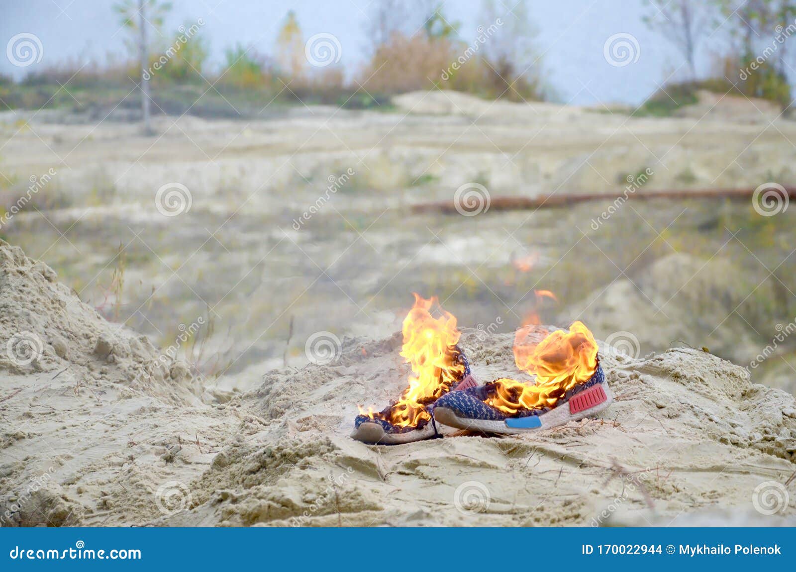 Burning Sports Sneakers or Gym Shoes on Fire Stand on Sandy Beach Coast ...