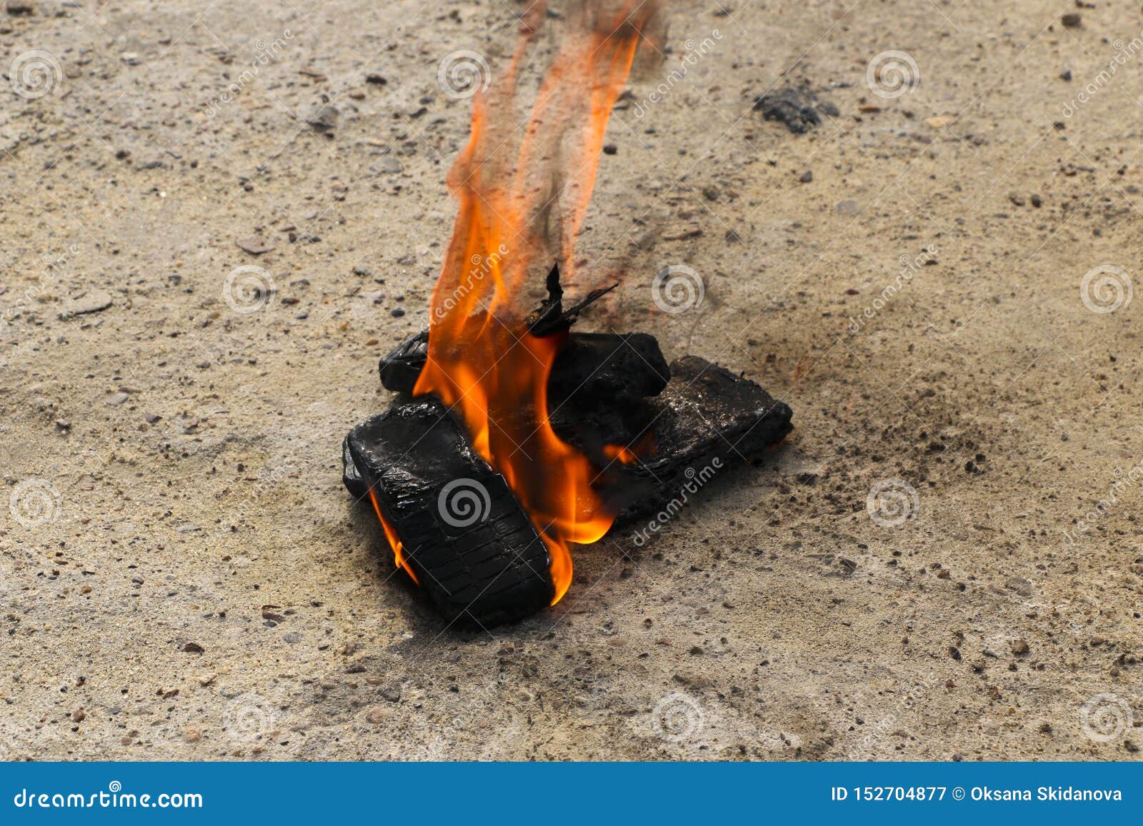 burnt mobile phones on textural concrete background. concept: danger of using low-quality cell phones