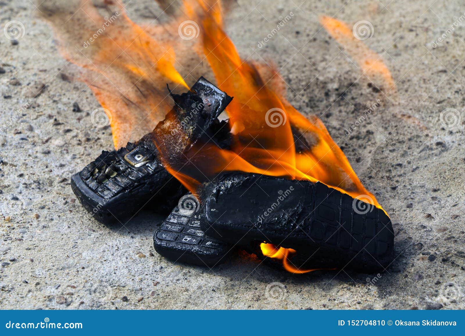 Burnt Mobile Phones on Textural Concrete Background. Concept: Danger of ...