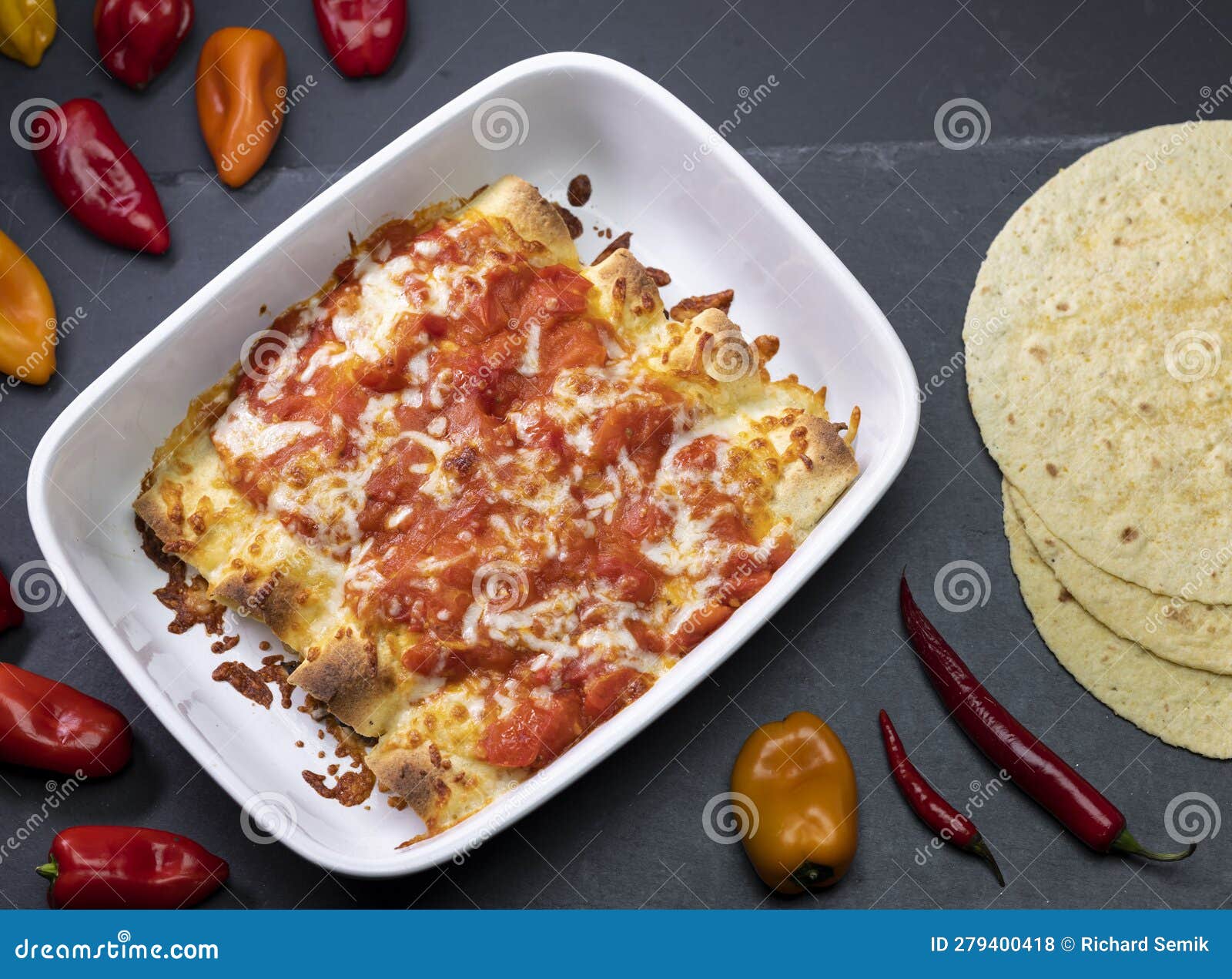 Burritos Baked with Tomato Sauce and Cheddar Cheese Stock Photo Image