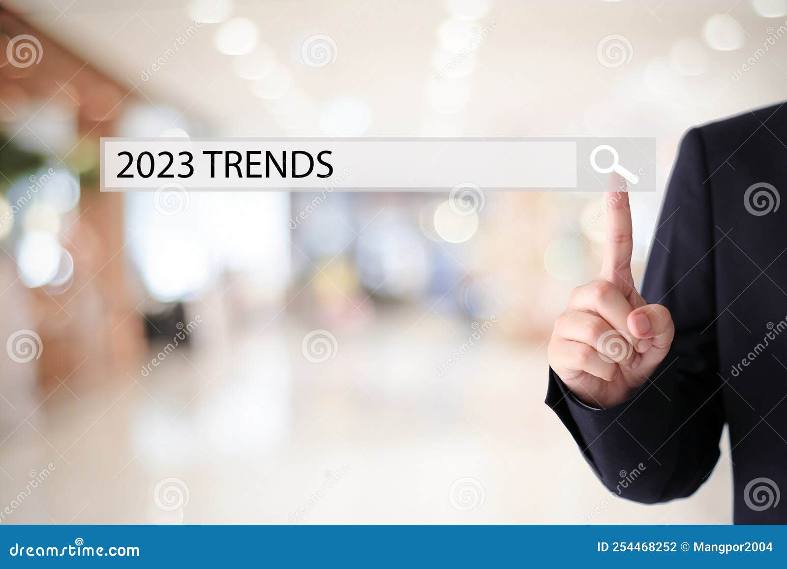 businesman hand touching 2023 trends search bar over blur office background, banner, seo 2023 business trends planning, success in