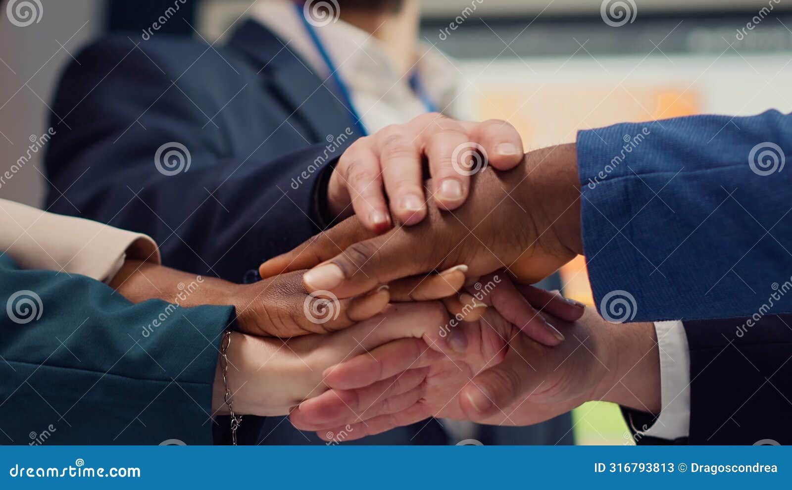business affiliates connecting hands and raising them up in celebration