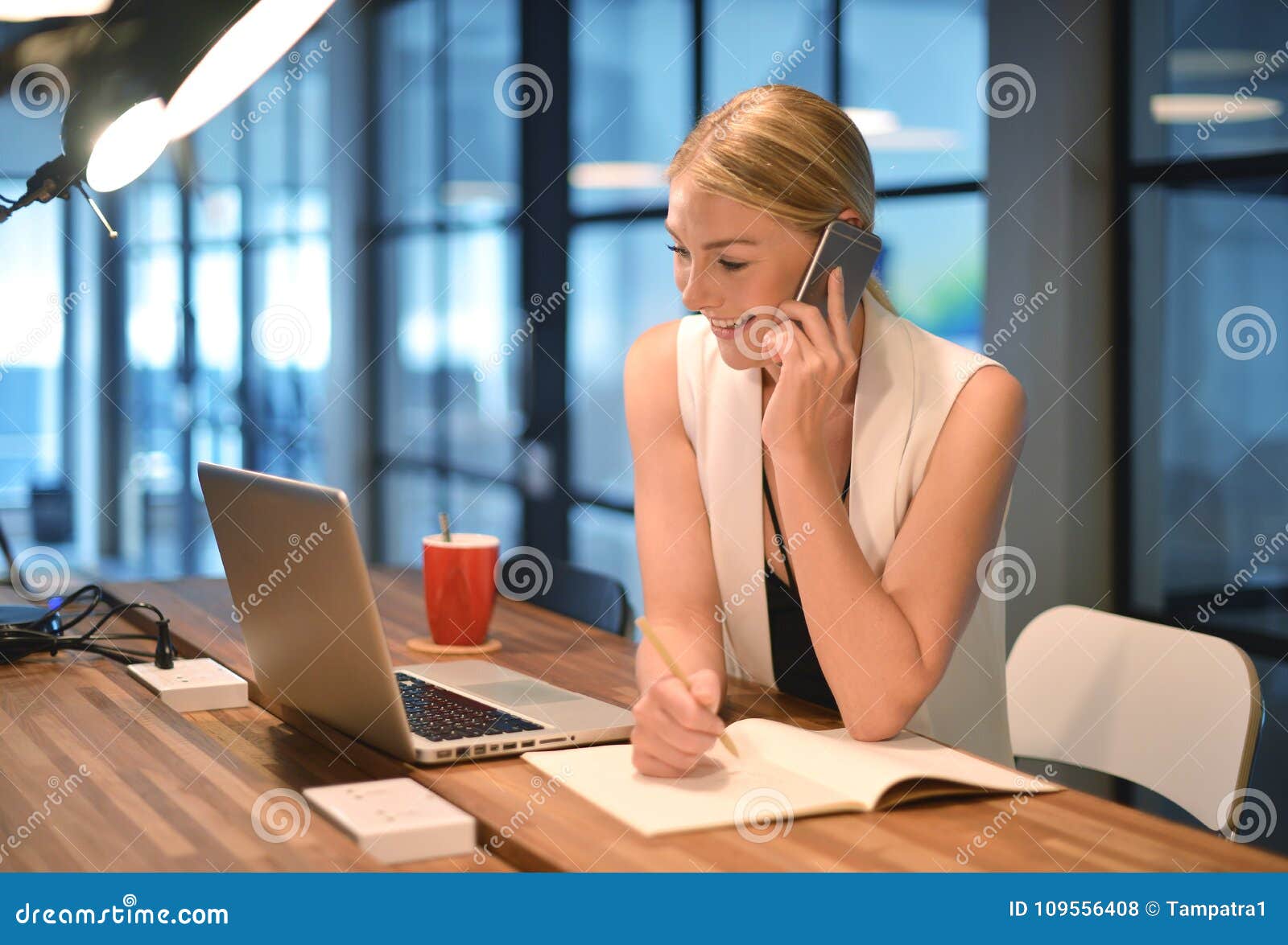 Blonde woman writing in library - wide 6