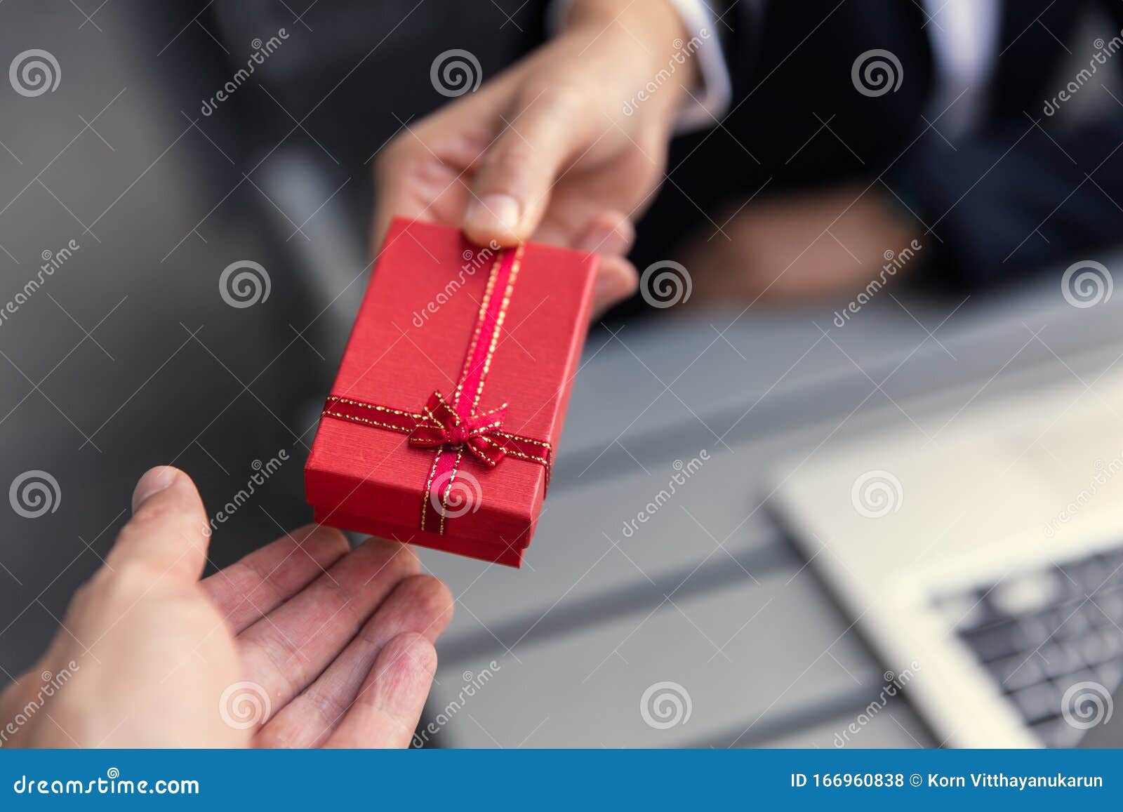 business boss giving present gift box to office staff partner for job bonus concept