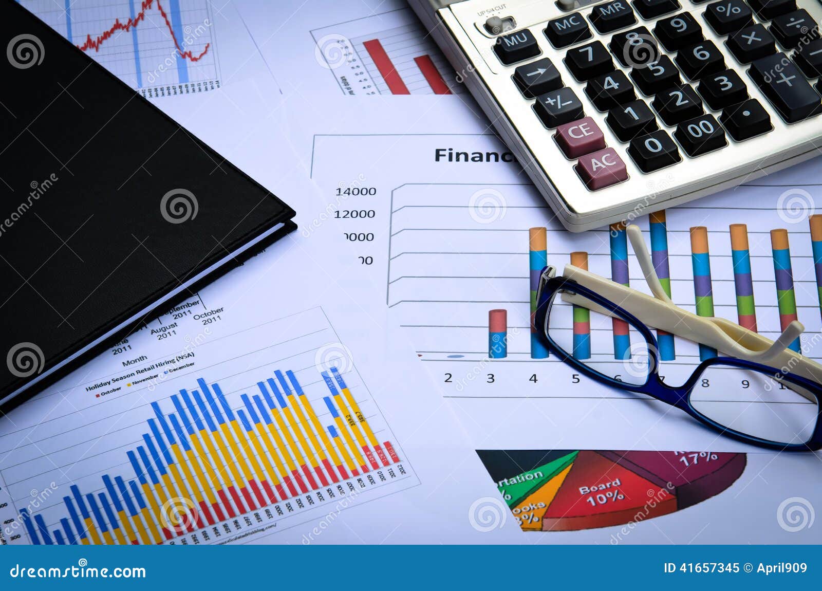 Business Charts and Graphs with Eye Glass and Book Note Stock Image
