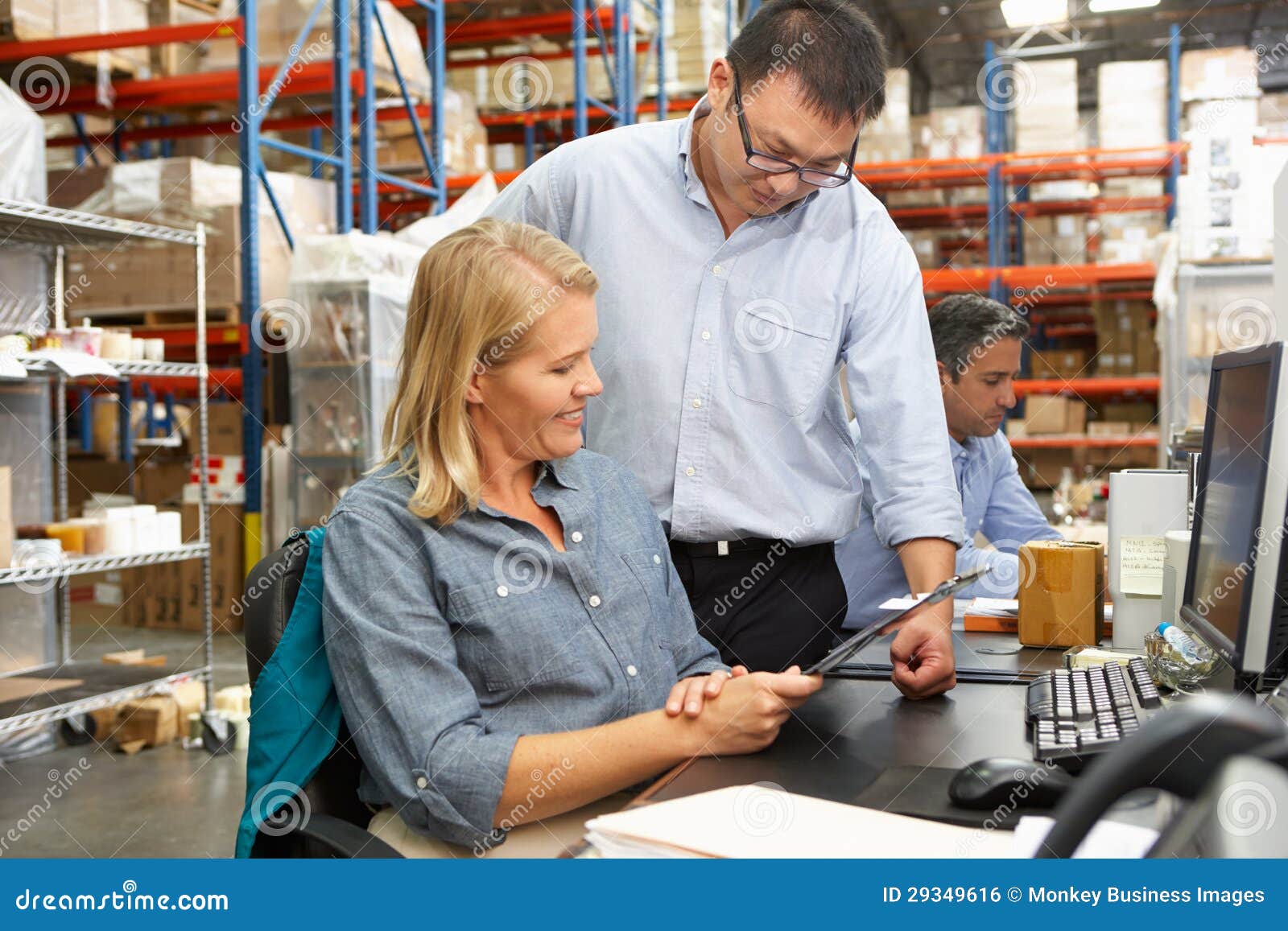 Business Colleagues Working at Desk in Warehouse Stock Photo Image of clipboard, businessman
