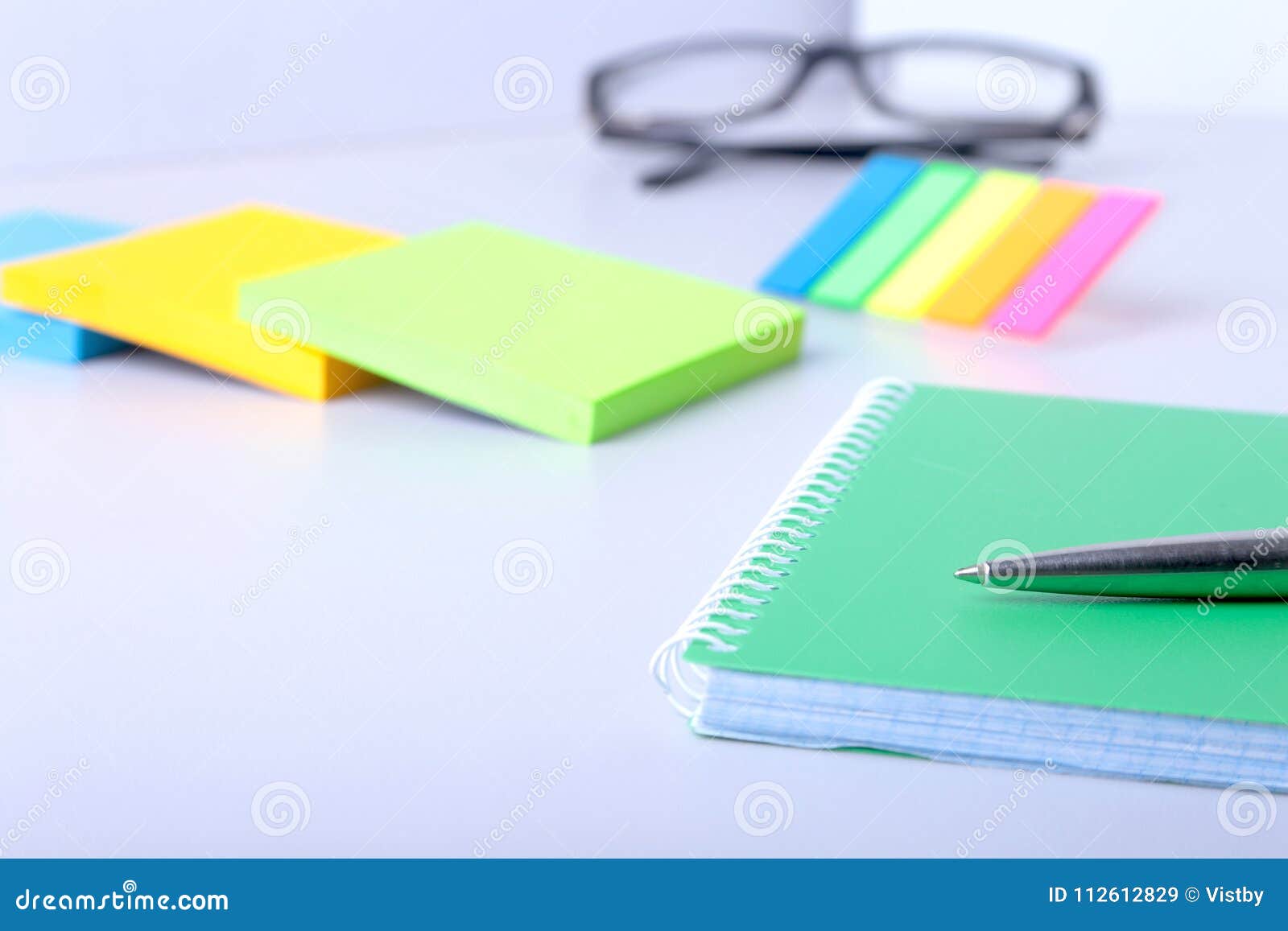 business concept. top view of kraft spiral notebook, glasses and pen on background for mockup.