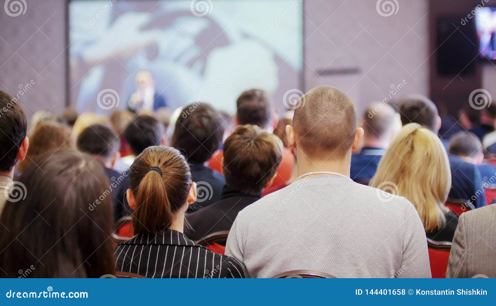A Business Conference. People Sitting on the Chairs and Watching the