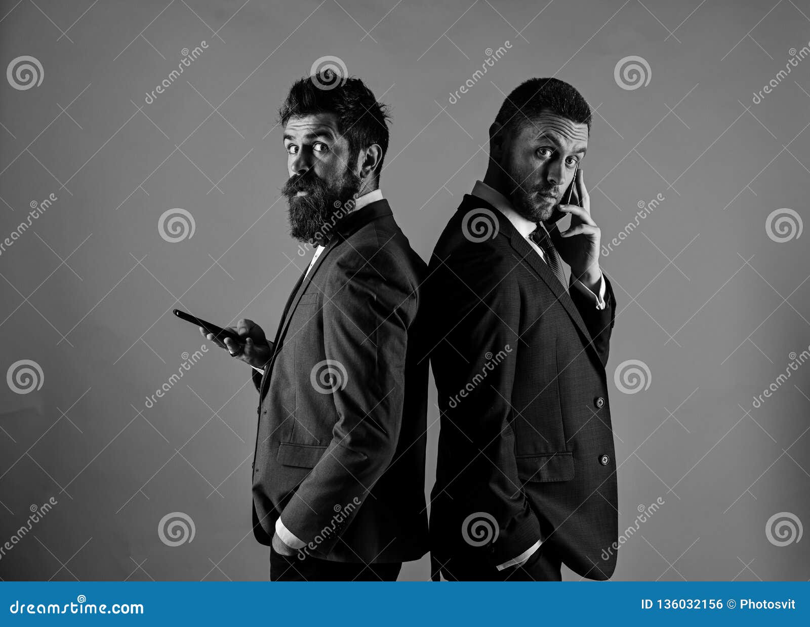 business conversation concept. machos in classic suits talk on phone