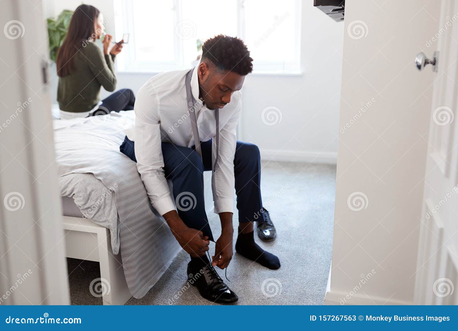 Business Couple In Bedroom Getting Ready For Work