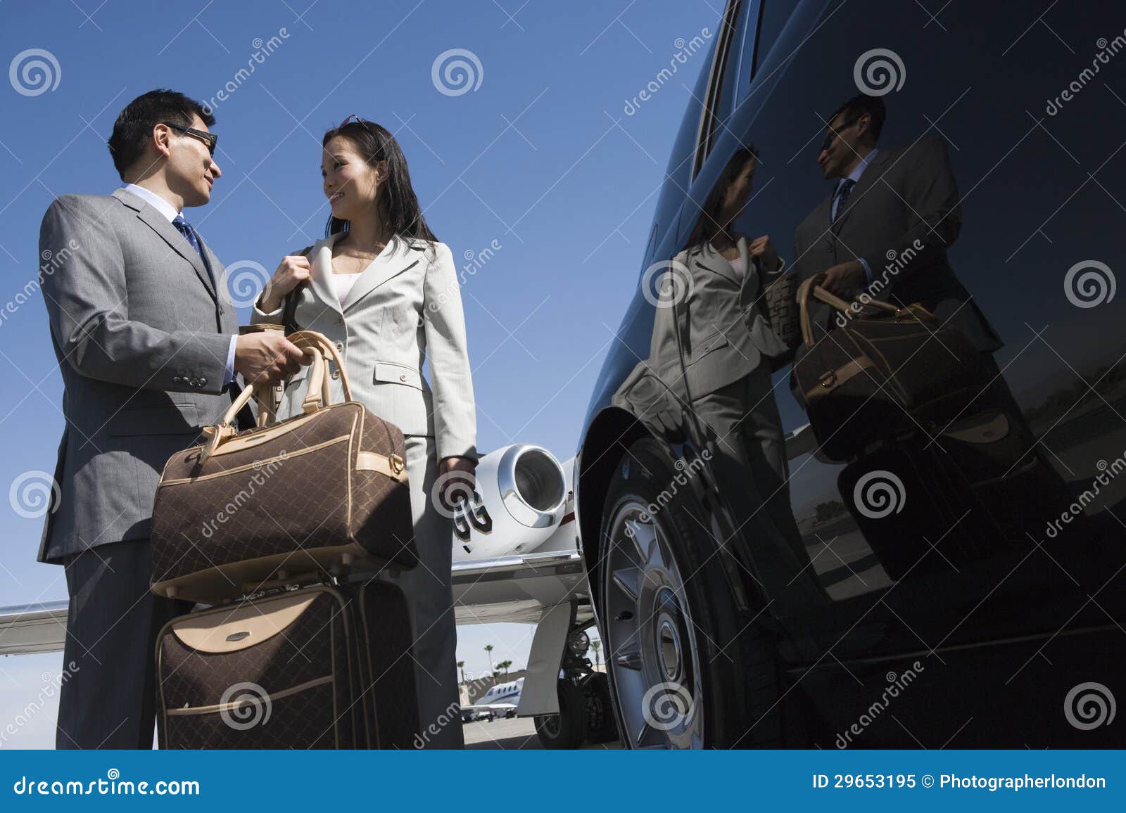 business couple standing together at airfield