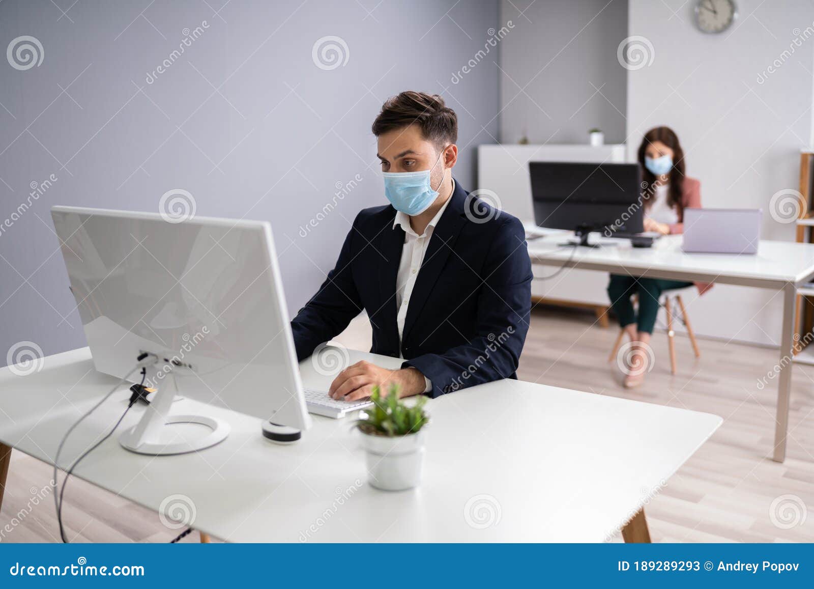 business employees in office wearing medical masks